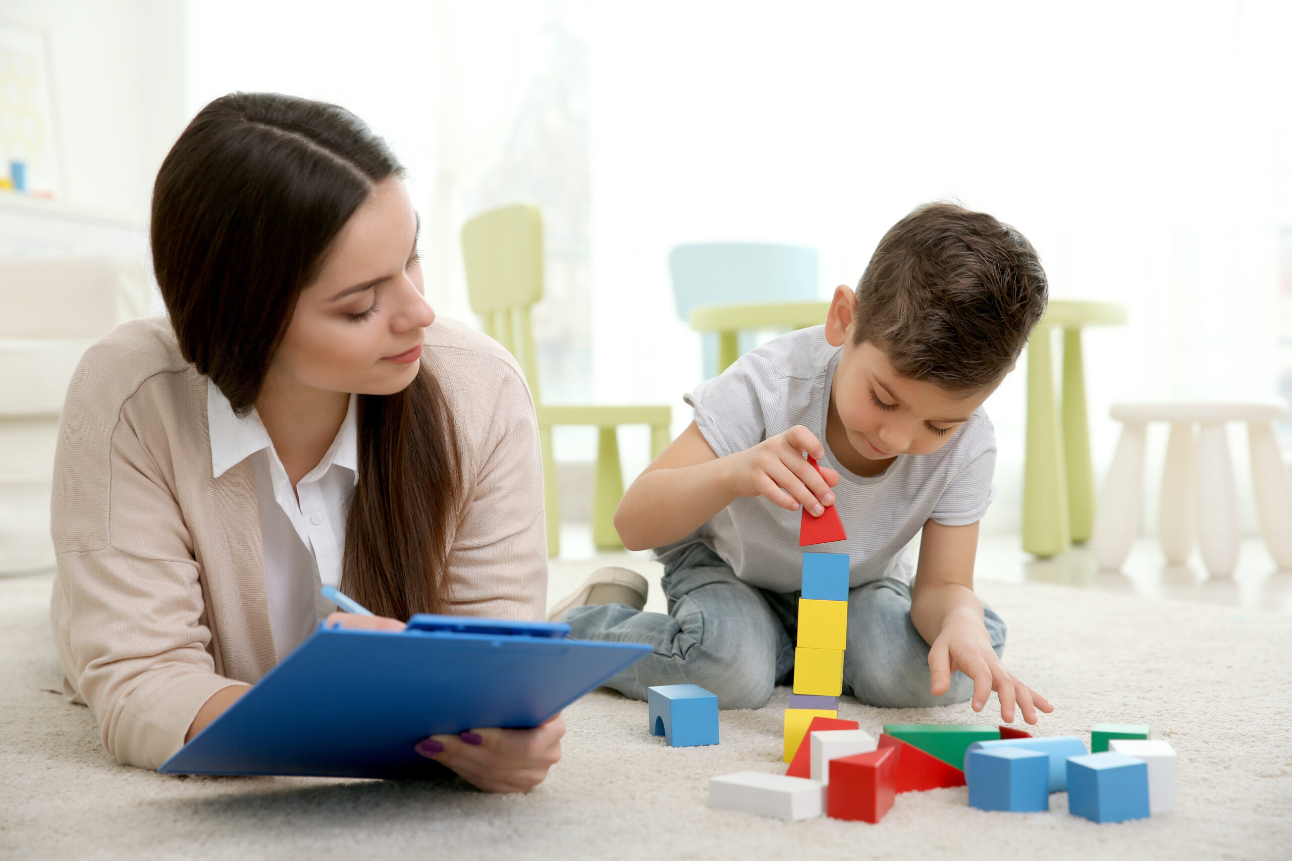 Young child psychologist working with little boy
